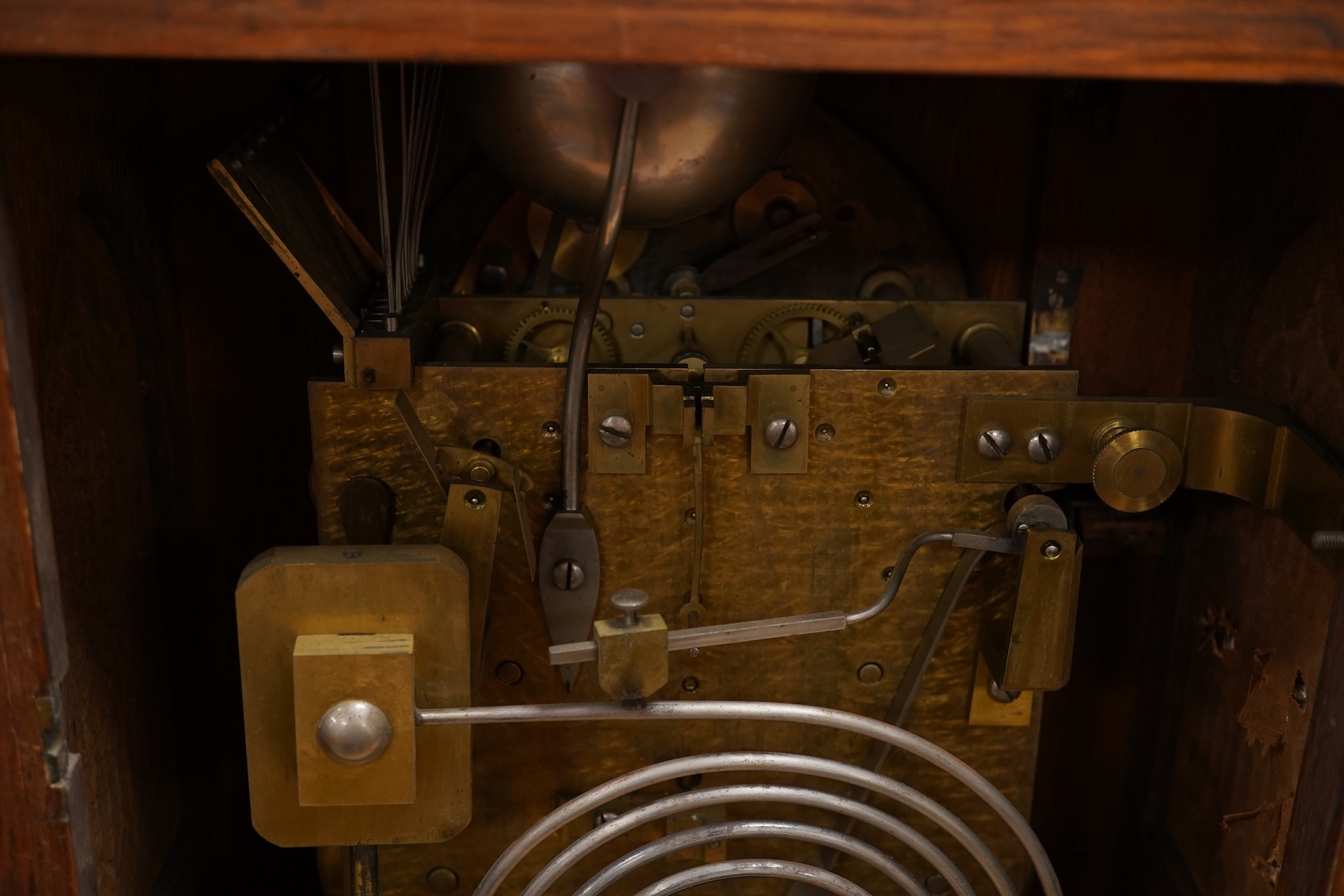 A German Gothic style oak mantel clock, early 20th century, with pendulum and keys, 49cm high